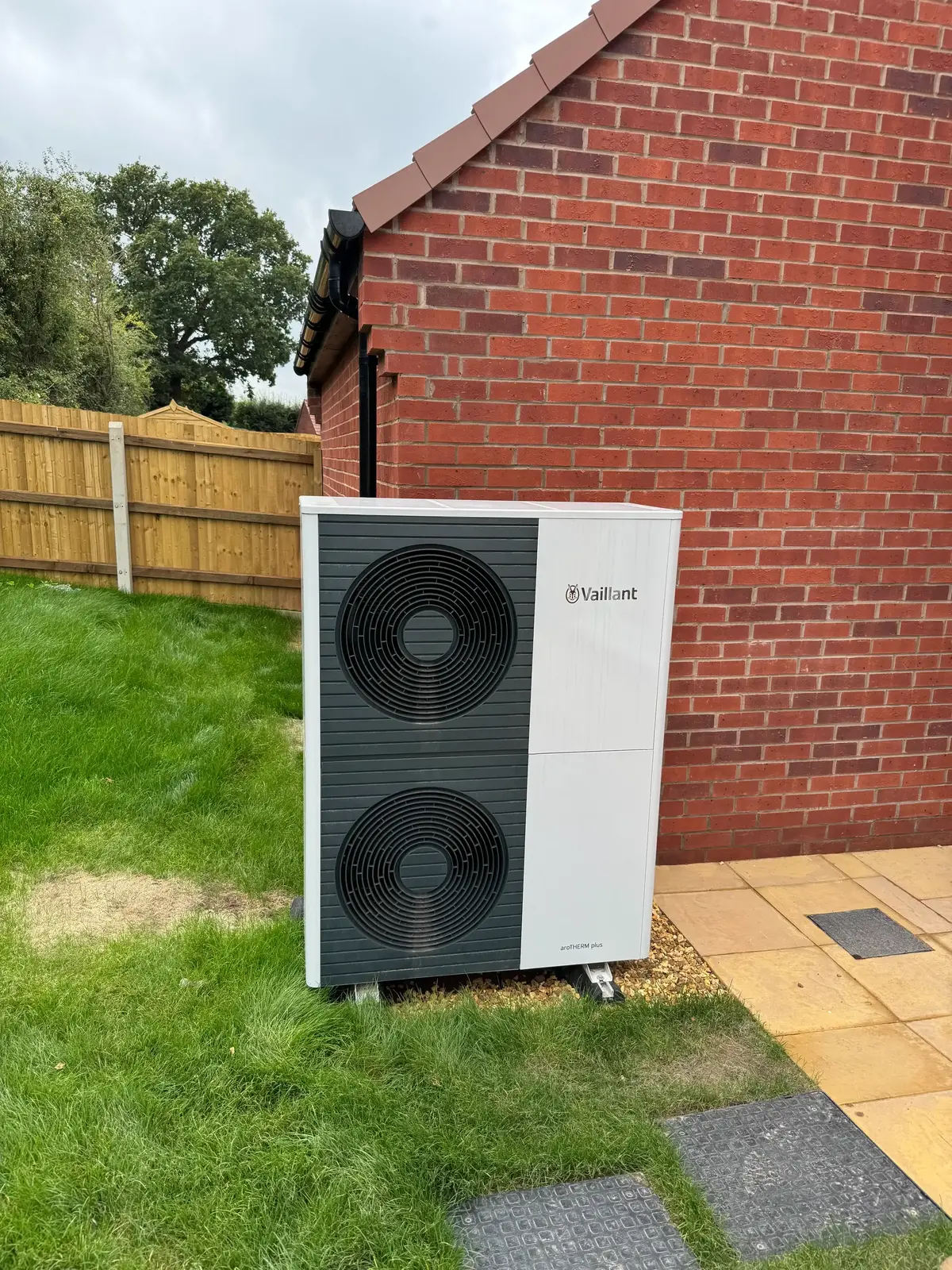 tall air source heat pump in a Tewkesbury garden