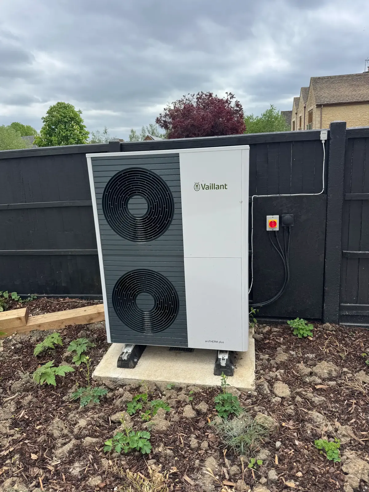 tall air source heat pump in a Gloucester garden